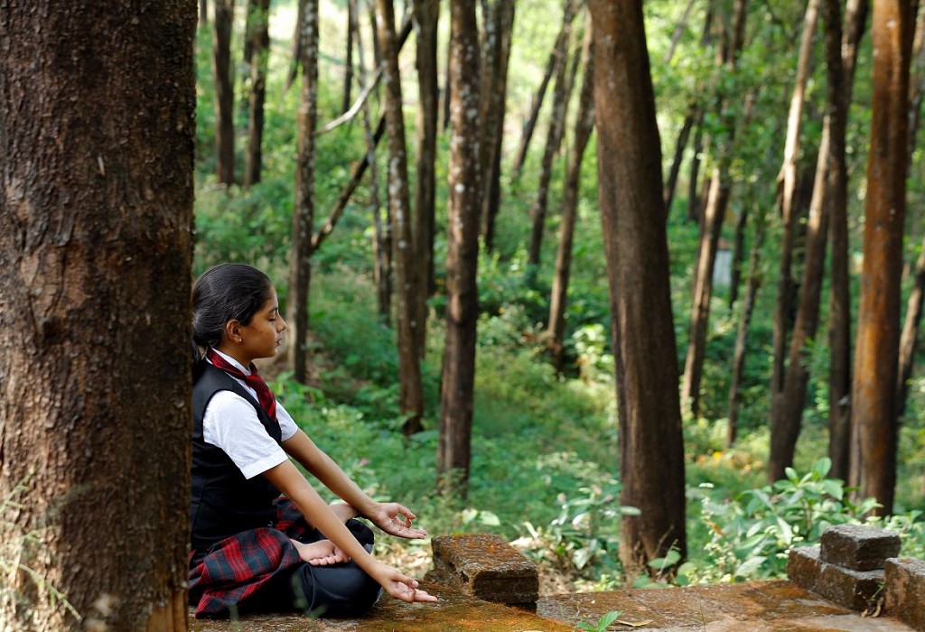 girl sitting in the woods and relaxing