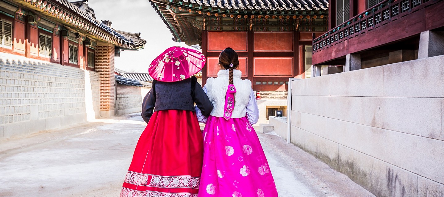 Korean temple with two people walking away from camera
