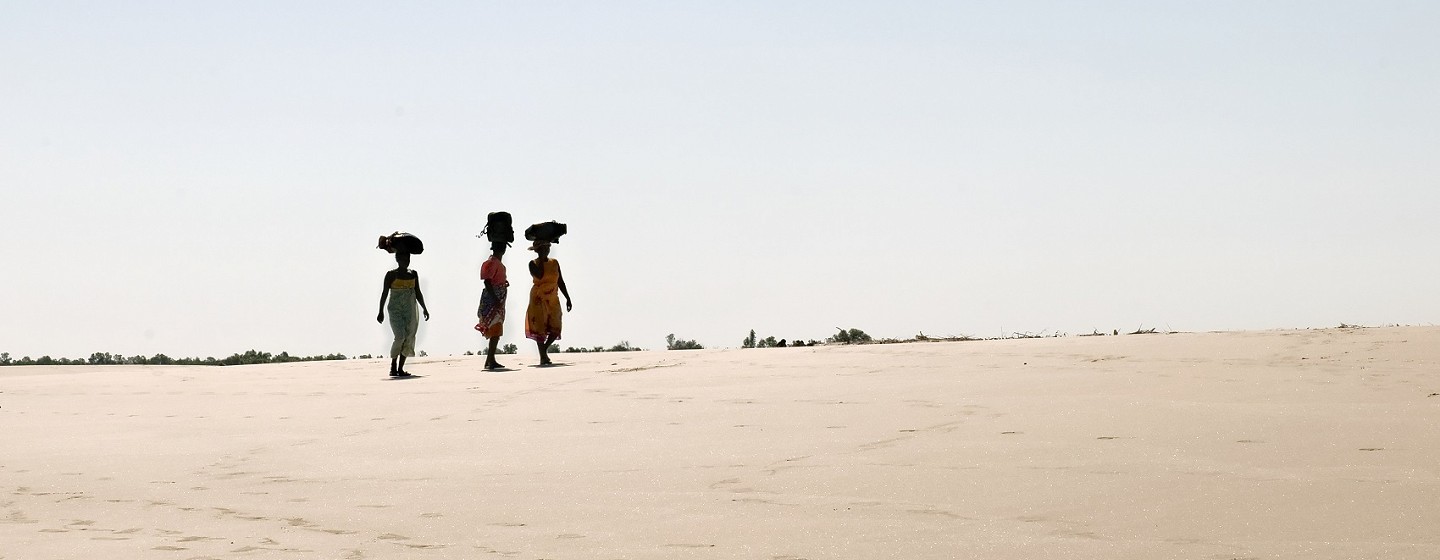 Women carrying goods on their heads. Madagascar